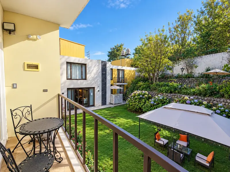 Balcony overlooking the garden and stone terraces