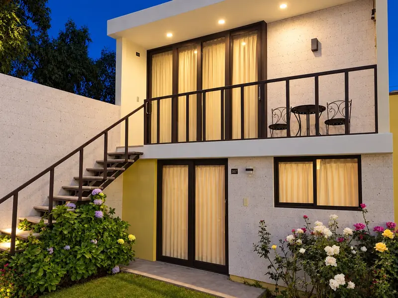 Outdoor staircase and balcony among flowers