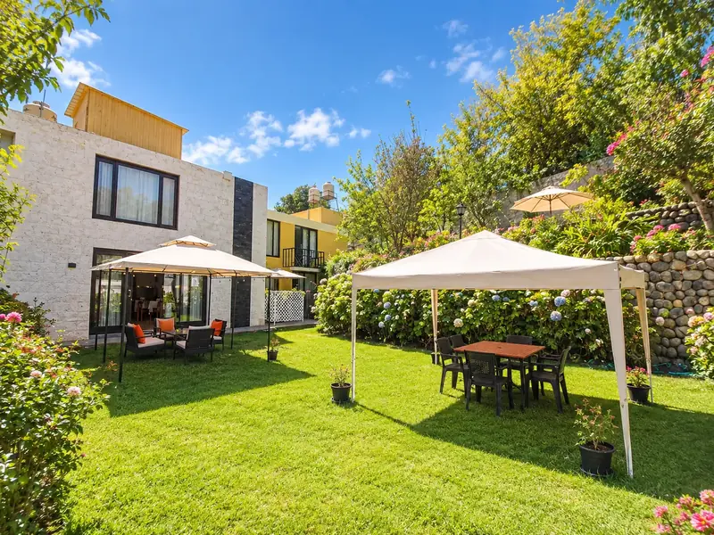 La Gruta seen from the garden, with canopies and tables on the lawn