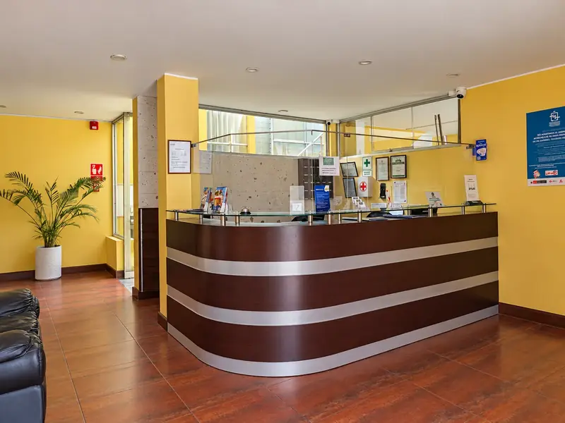 Reception with a wooden counter and parquet floor