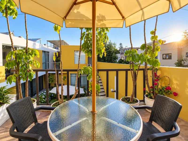 Table with a parasol on the terrace at sunset