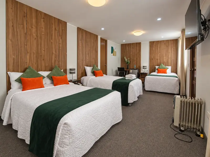 Triple Room with three beds and wood panelling